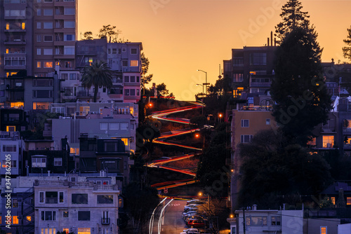 High angle view of illuminated homes on Lombard Street in San Francisco, California at sunset with car light trails