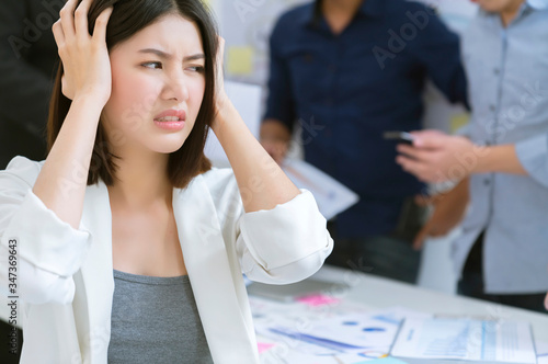 asian female office worker upset bore  hand touch head with troble and problem headache with unhappy result meeting with business colleague problem and stressful business discussion ideas concept photo