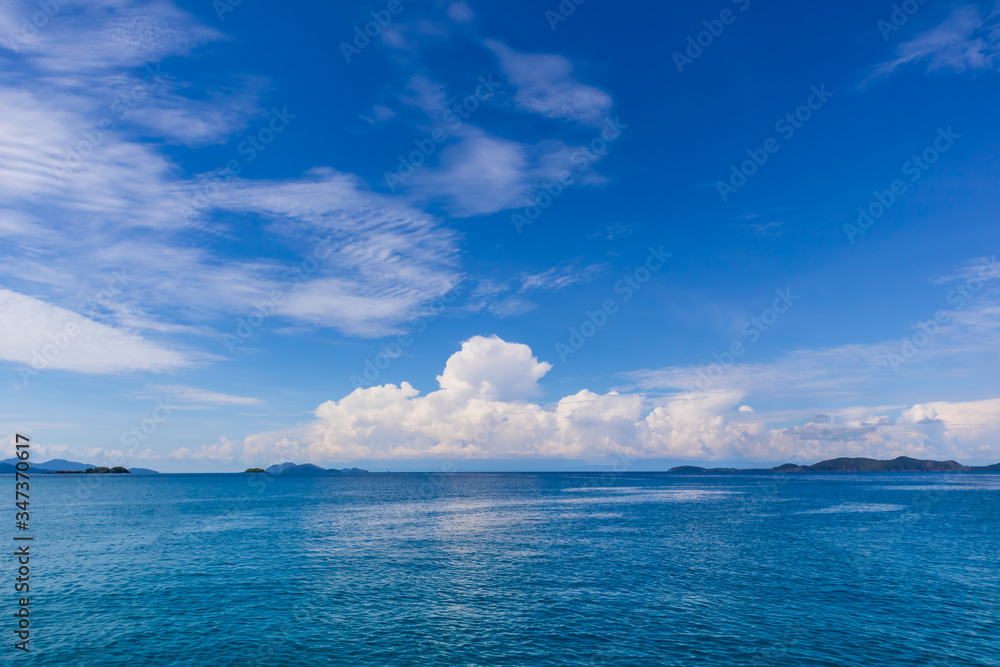 Blue sky with white cloud and deep blue sea