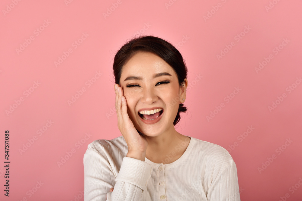 Asian woman laughing and enjoy on pink background, Portrait of happy smiling middle age woman in casual clothes looking at the camera. Asian woman laughing and enjoy on pink background, Portrait of happy smiling middle age woman in casual clothes looking at the camera.