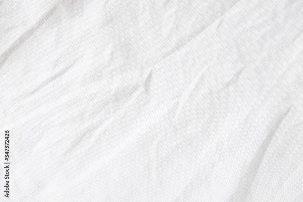 Obraz premium Wrinkled White fabric close up shot of good quality Cotton and polyester shirt. formal wear for office worker . Background texture concept with copy space for text.