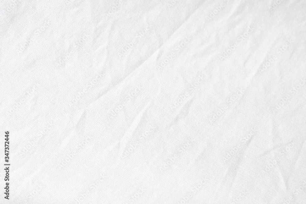 Obraz premium Wrinkled White fabric close up shot of good quality Cotton and polyester shirt. formal wear for office worker . Background texture concept with copy space for text.