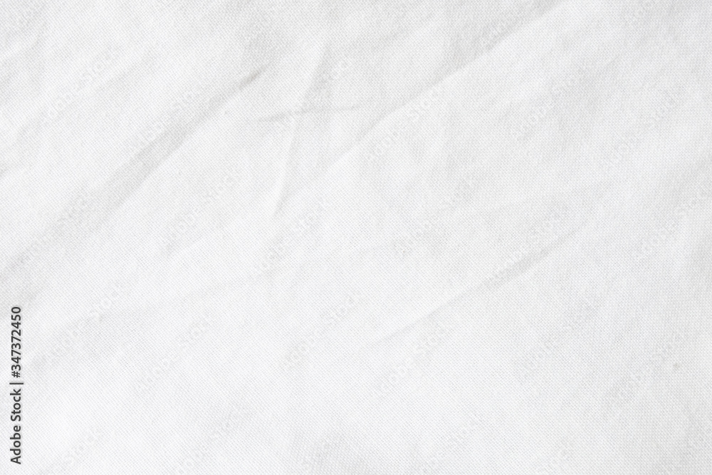 Wrinkled White fabric close up shot of good quality Cotton and polyester shirt. formal wear for office worker . Background texture concept with copy space for text. Wrinkled White fabric close up shot of good quality Cotton and polyester shirt. formal wear for office worker . Background texture concept with copy space for text.