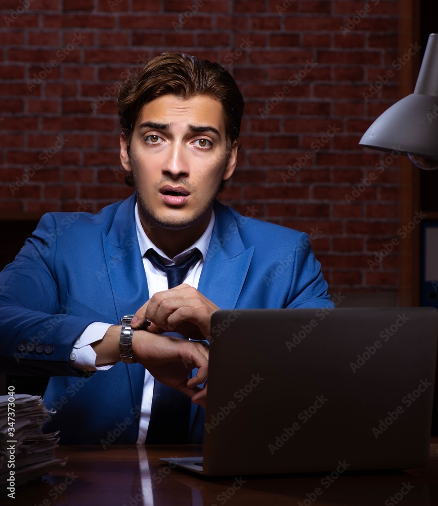 Young businessman working in the office at night Young businessman working in the office at night