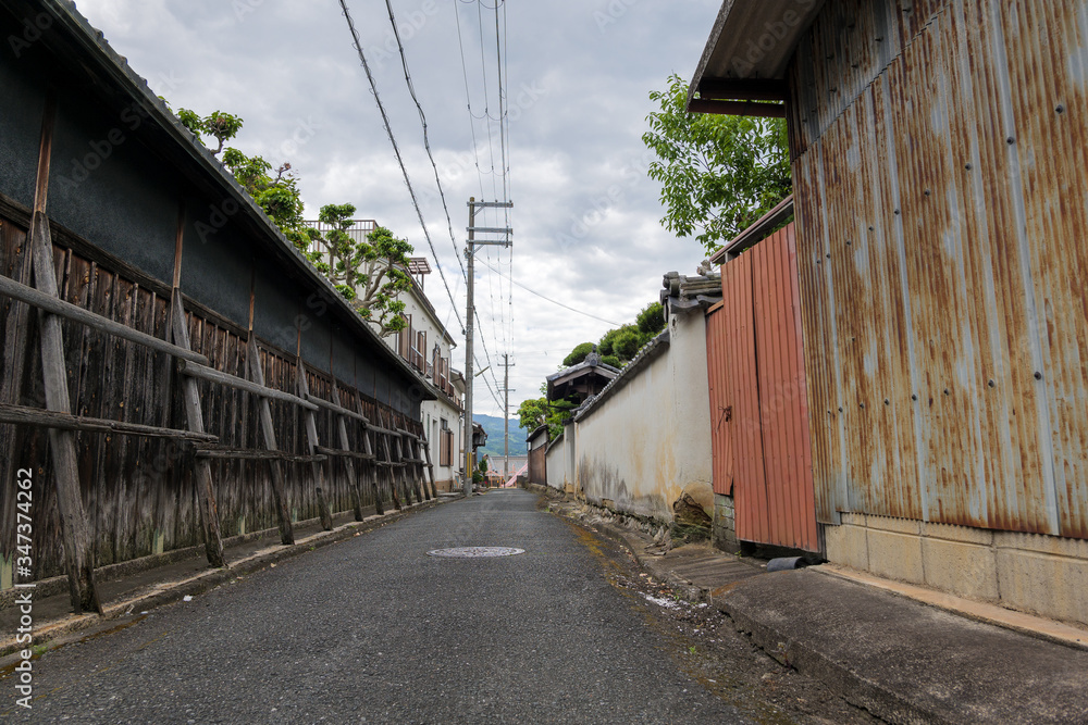 Japanese village road sparsely populated by coronavirus