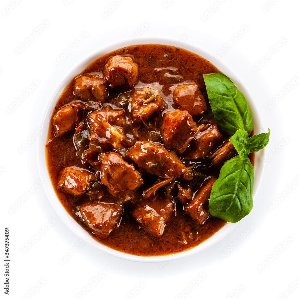Goulash - roast meat in sauce on white background
Goulash - roast meat in sauce on white background