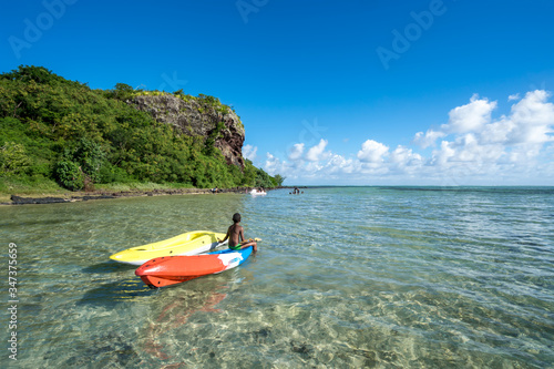 Local people swim in the ocean in a picturesque lagoon on the island of Mauritius