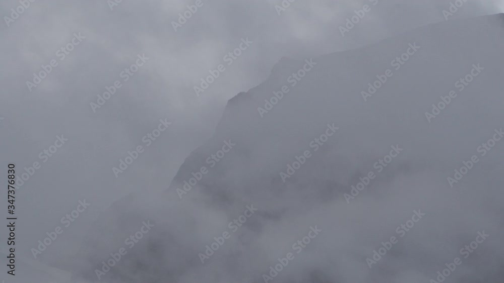 Low angle view of mountain peak surrounded by mist in forest against sky - British Columbia, Bella Coola Low angle view of mountain peak surrounded by mist in forest against sky - British Columbia, Bella Coola