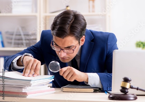Young handsome judge working in court