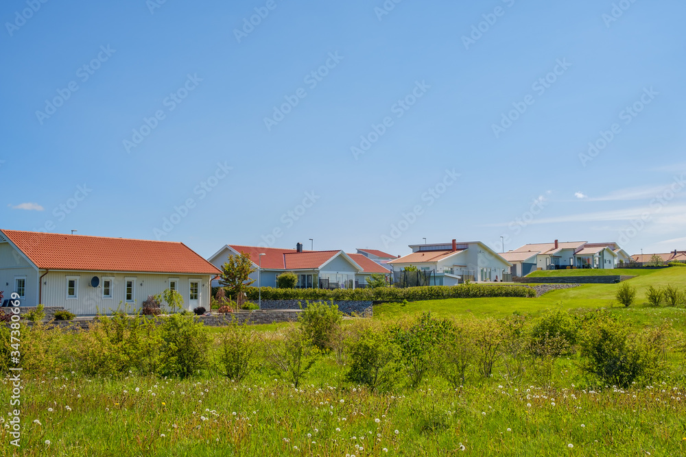 Residential houses with gardens in the summer Residential houses with gardens in the summer
