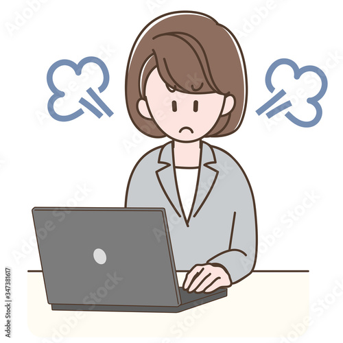 パソコンの前で怒るスーツの女性