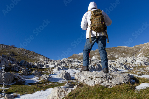 hiker on the top of a mountain and snow