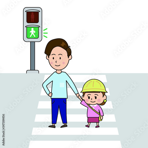 青信号を渡る父と女の子
