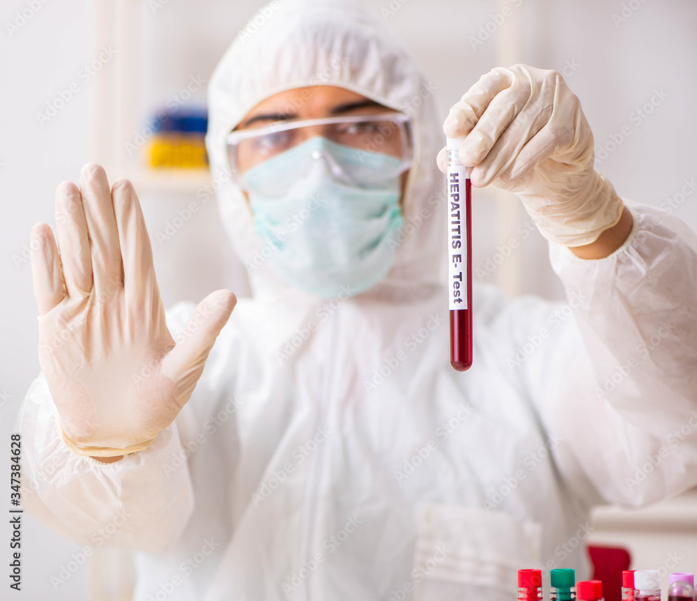 Young handsome lab assistant testing blood samples in hospital Young handsome lab assistant testing blood samples in hospital