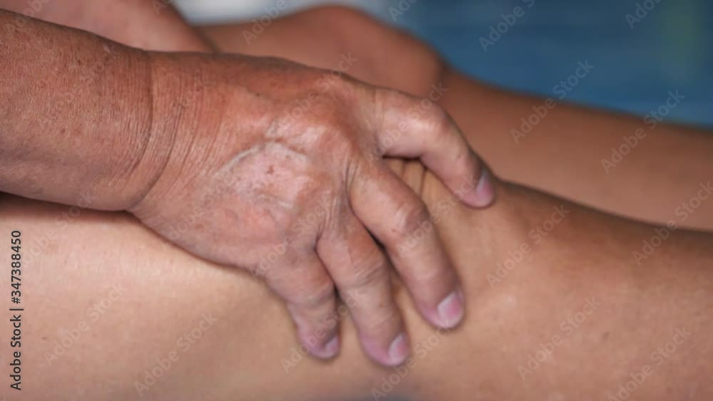 Hands are squeezing knees from the pain in that area. Hands are squeezing knees from the pain in that area.