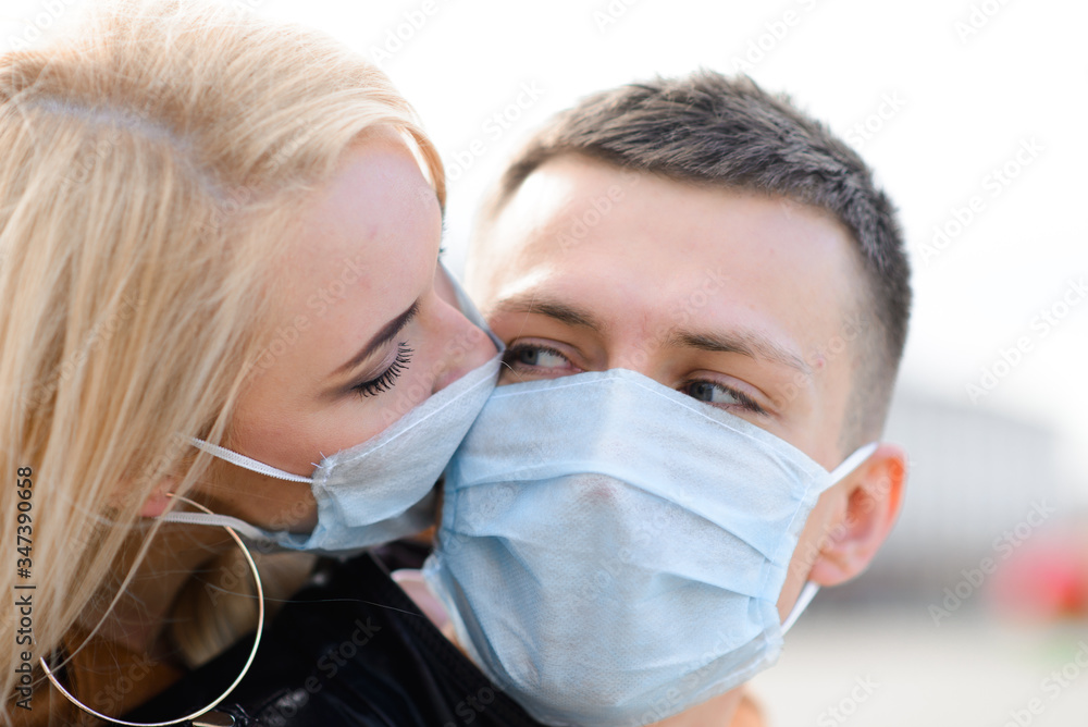 Couple wears a medical mask walking on the street of the city during the spread of news about the epidemic of coronavirus.