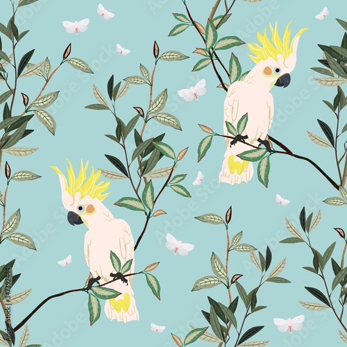 Seamless vector pattern with white parrots sitting on green branches on a gentle light blue background. Square template with exotic birds and leaves for fabric and wallpaper