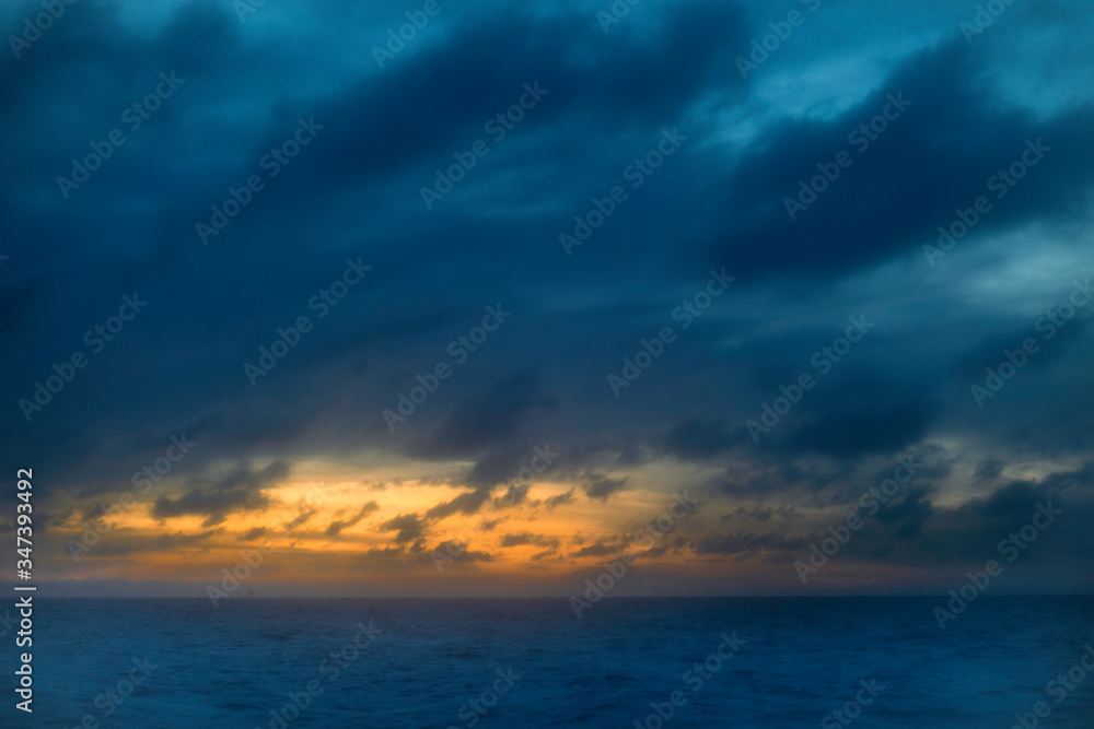 Photo of sunset clouds over ocean 