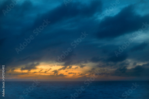 Photo of sunset clouds over ocean 
