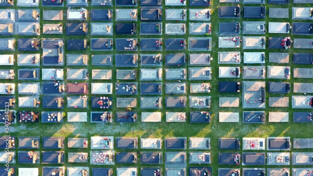 Tombs in a large cemetery with grid layout - aerial top down view. Packed graves in an orthodox christian graveyard in a big city. Zagoric in Podgorica Montenegro Europe. Abstract footage. Tombs in a large cemetery with grid layout - aerial top down view. Packed graves in an orthodox christian graveyard in a big city. Zagoric in Podgorica Montenegro Europe. Abstract footage.