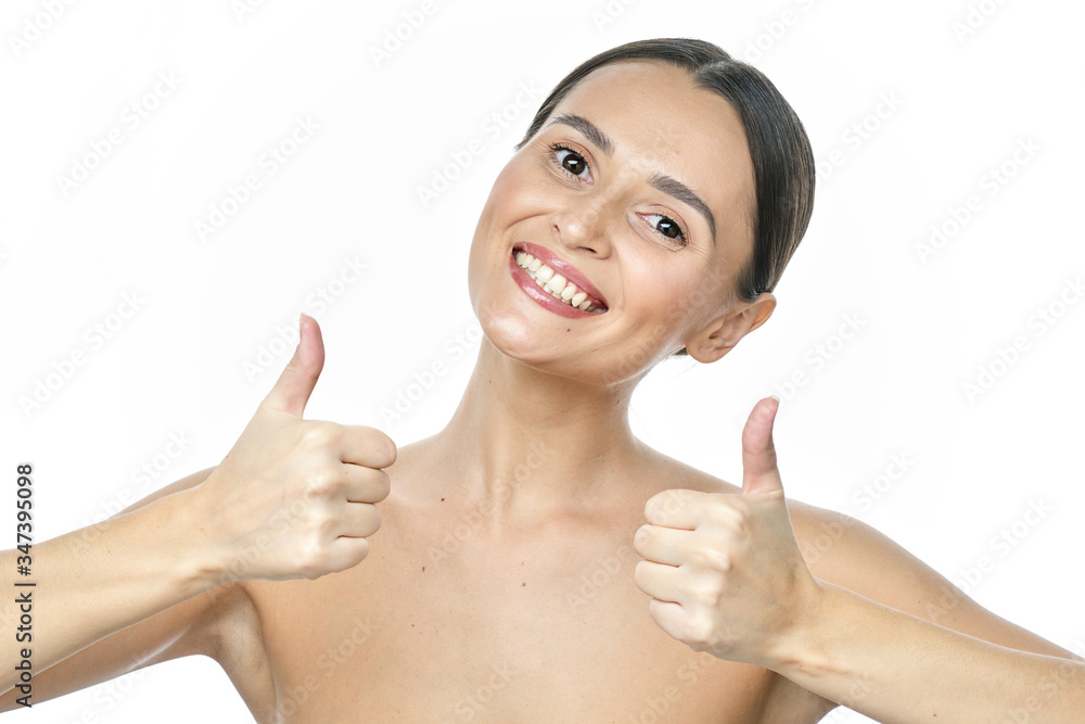 Close up portrait of a girl with big eyes and clear skin on a white background with a beautiful wide smile and white teeth Close up portrait of a girl with big eyes and clear skin on a white background with a beautiful wide smile and white teeth