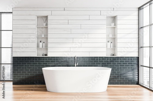 Wooden and gray brick bathroom interior with tub