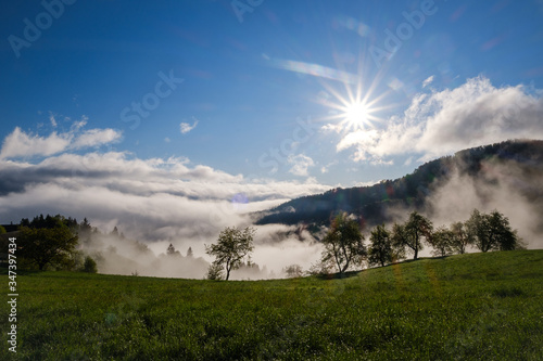 View through clouds and morning fog from Rantovse towards Skofja Loka hills