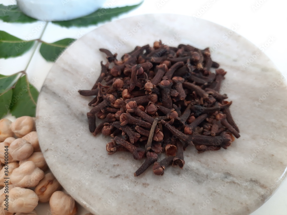 Neem leaves in Mortar Grinder drug and ingredient herbs on plain white background Neem leaves in Mortar Grinder drug and ingredient herbs on plain white background