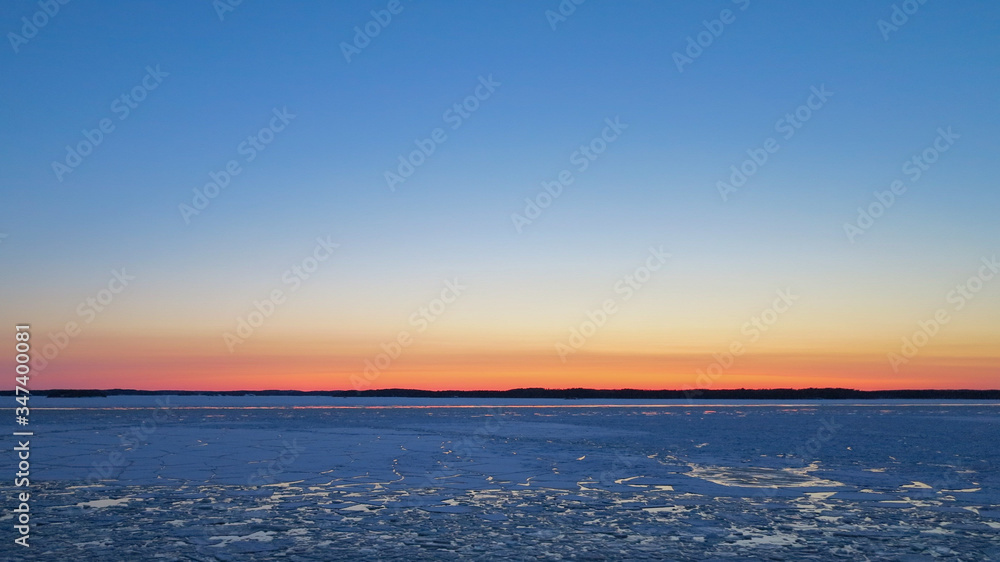 Ice drifts on the Baltic sea in spring evening, after sunset.