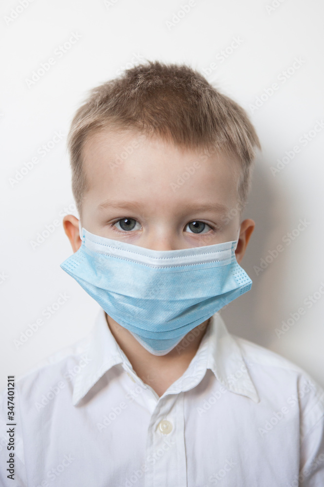 Cute boy in a medical mask. Quarantined children due to an epidemic. Cute boy in a medical mask. Quarantined children due to an epidemic.