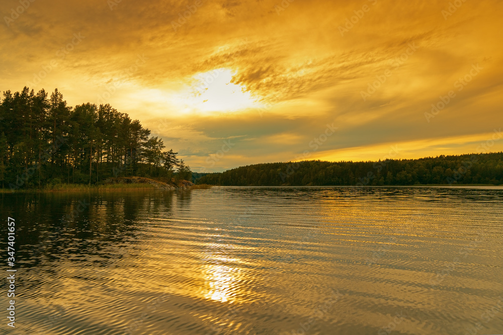 Obraz premium Ladoga Lake at sunset. Bright red and yellow color clouds of sky. Travel to Russia. Leningrad region.