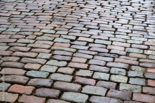 "Natural paving granite stone on road. Paving stone in old city. Wet boulder.."