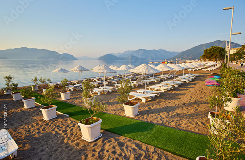 Deserted beach in the morning sun. The beach at dawn. Empty sunbeds. Beach without people. Marmaris