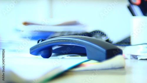 Very angry, unpredictable male, person, operating with telephone, waiting for a call, ending it. Office. Close up. Bright light.