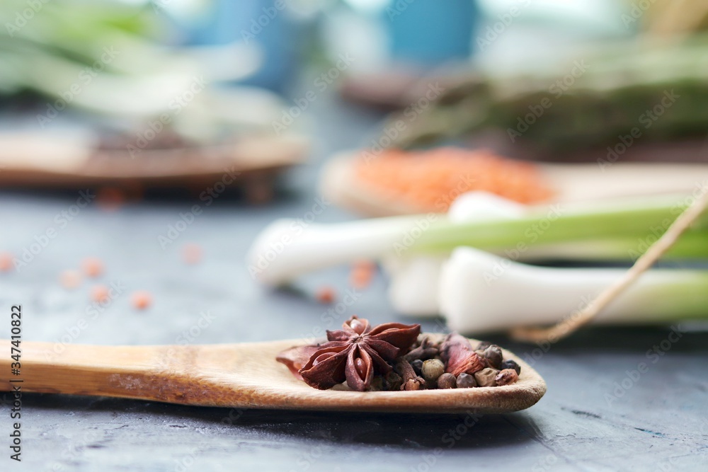 Spicy herbs, asparagus, lemons, seasonings, lentils on the kitchen table for preparing healthy homemade food from organic products Spicy herbs, asparagus, lemons, seasonings, lentils on the kitchen table for preparing healthy homemade food from organic products