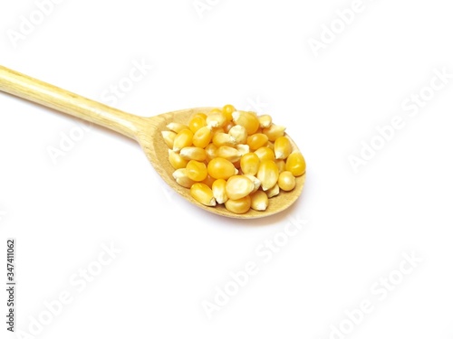 corn and wood spoon isolated on a white background