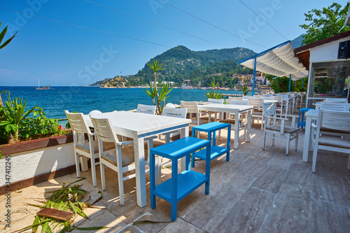 Fototapeta Naklejka Na Ścianę i Meble -  Traditional greek street cafe with flowers.