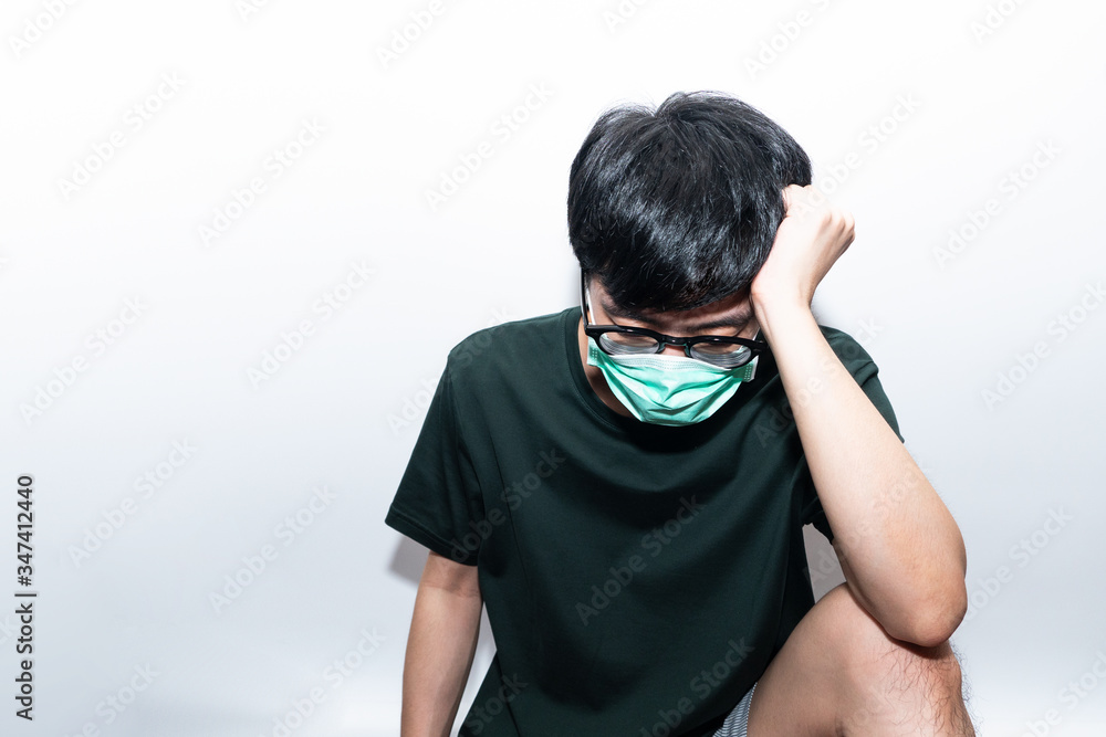 Asian man wearing protective mask depressed and stressed of Coronavirus or COVID19 epidemic world economic slowdown crisis. unemployment people lay off from work feeling serious of financial payment Asian man wearing protective mask depressed and stressed of Coronavirus or COVID19 epidemic world economic slowdown crisis. unemployment people lay off from work feeling serious of financial payment