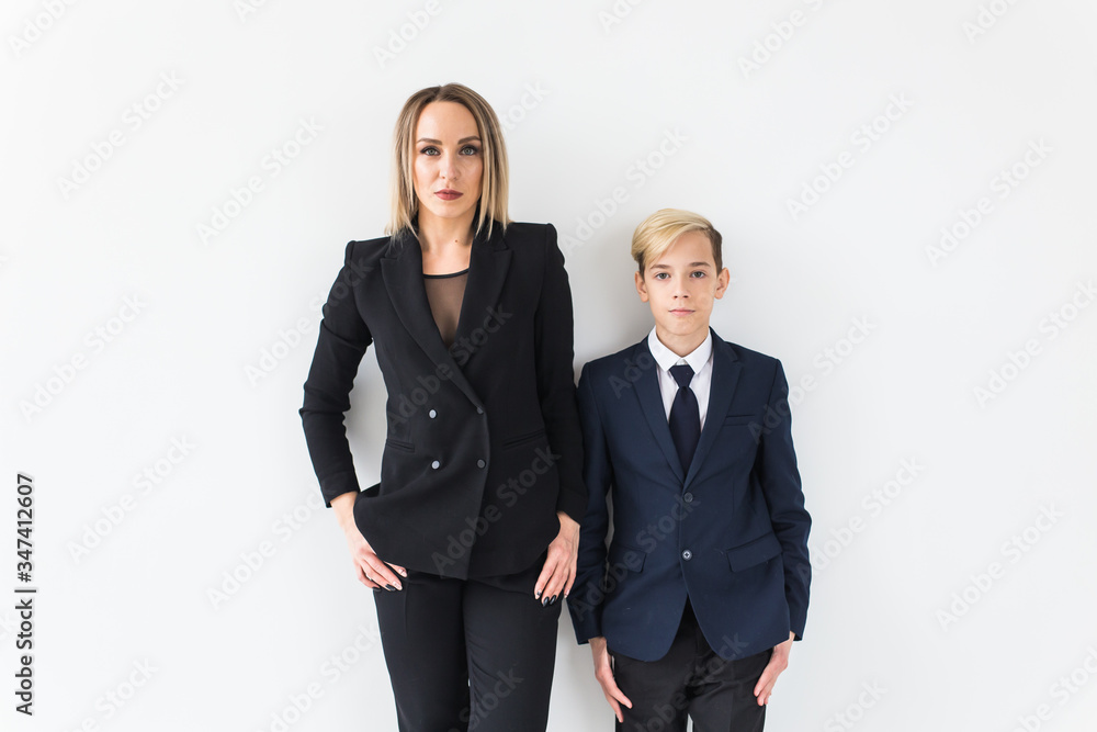 Parenting, family and single parent concept - A happy mother and teen son smiling on white background. Parenting, family and single parent concept - A happy mother and teen son smiling on white background.