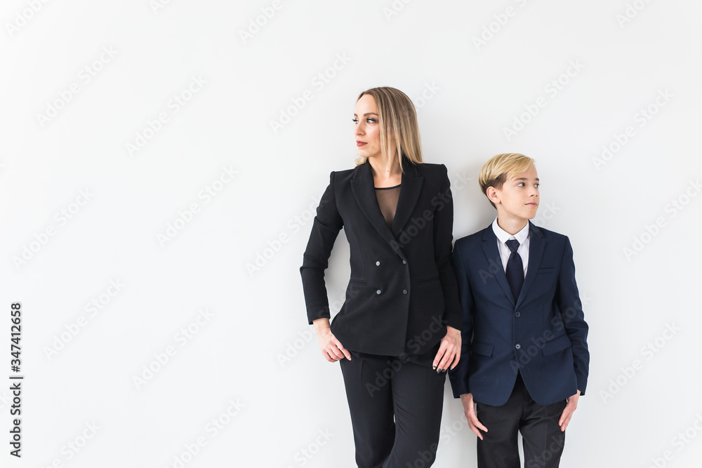 Parenting, family and single parent concept - A happy mother and teen son smiling on white background. Parenting, family and single parent concept - A happy mother and teen son smiling on white background.