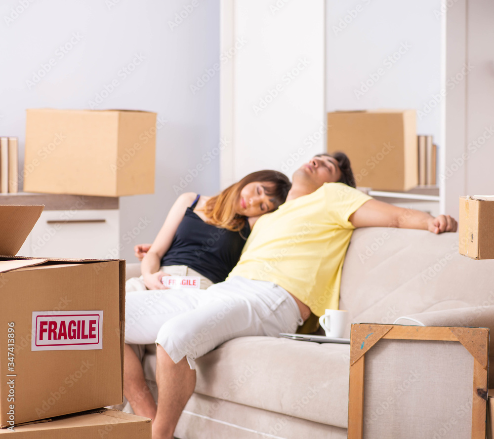 Young couple moving to new flat with fragile things Young couple moving to new flat with fragile things