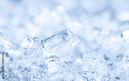 Broken ice cubes, winter background, texture of ice crystals. Frozen water.