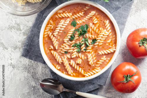 Fotografie Tomato soup with fusilli pasta in the bowl