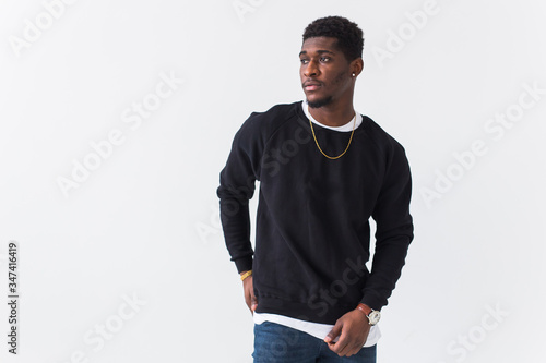 Youth street fashion concept - Portrait of confident sexy black man in stylish sweatshirt on white background.