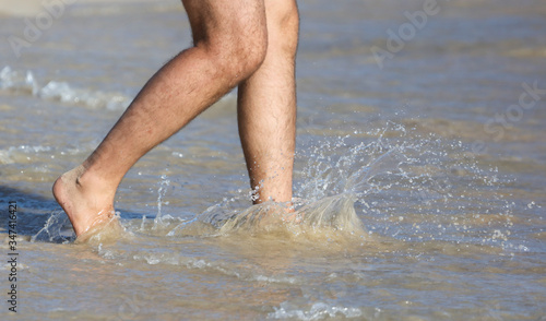 A man in swimming trunks on the seashore. © schankz