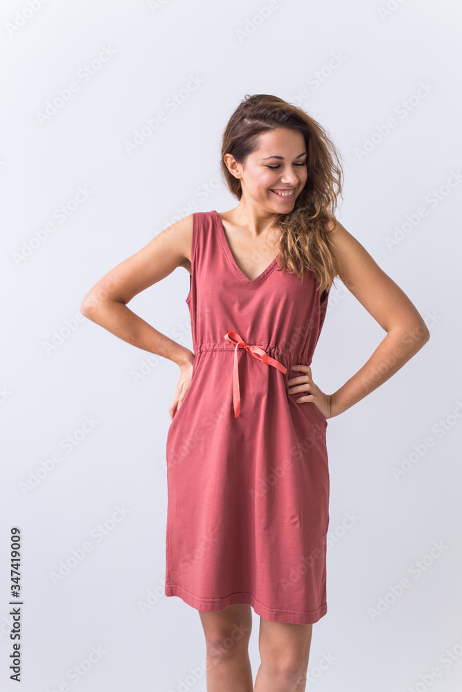 Fashion, summer and vacation concept - beautiful female model in brown dress on white background. Fashion, summer and vacation concept - beautiful female model in brown dress on white background.