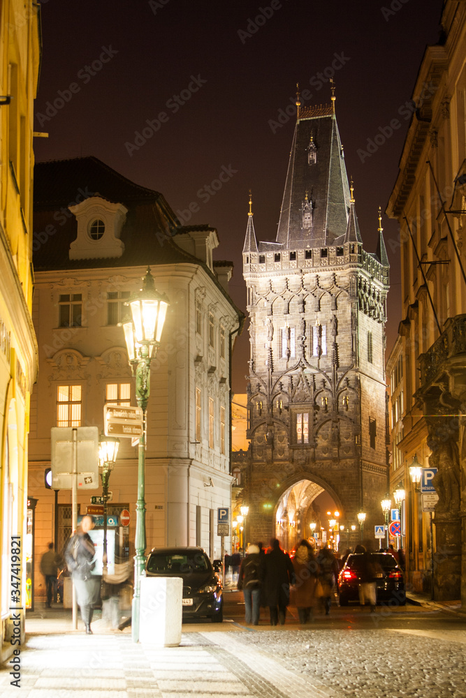 Night view of the Powder Tower or Powder Gate. This landmark is a Gothic tower in Prague, Czech Republic. It is one of the original city gates, dating back to the 11th century.