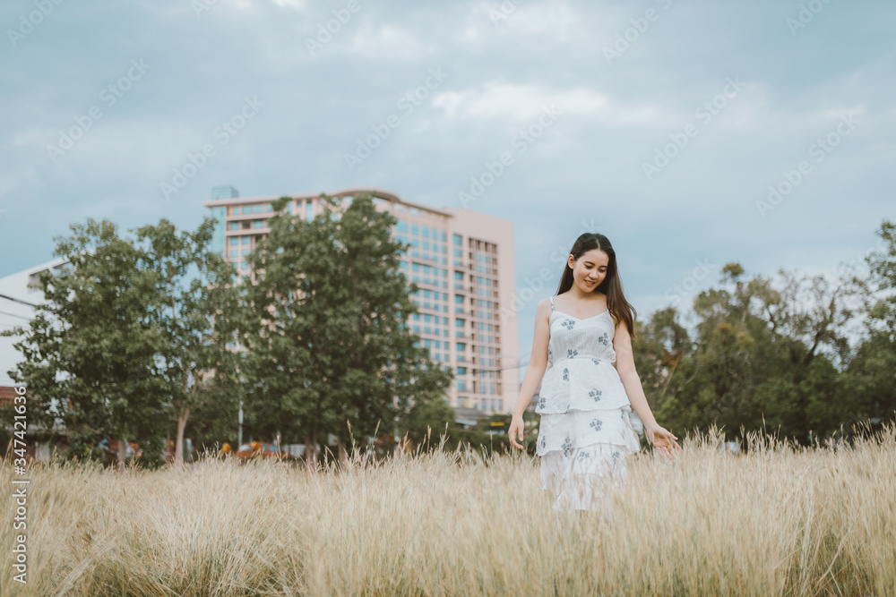 Beautiful young woman enjoying on natural meadow and have a feeling freedom in downtown. Enjoy feeling. Freedom concept Beautiful young woman enjoying on natural meadow and have a feeling freedom in downtown. Enjoy feeling. Freedom concept