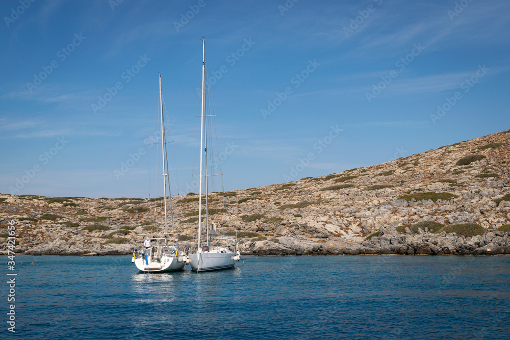Anchorage of two sailing boats near a small island Anchorage of two sailing boats near a small island