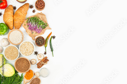 Healthy cereals, vegetables and spices on a light background. Healthy eating . Great food. Culinary background for recipes. Banner. Copy space.